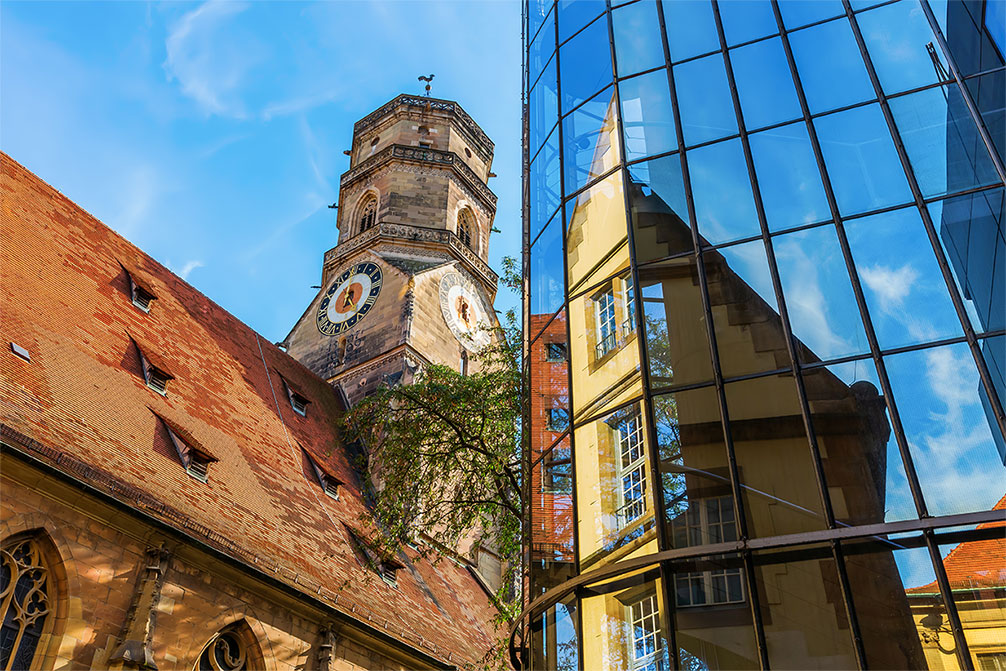 Stiftskirche With Reflections In A Glass Facade In Stuttgart, Germany